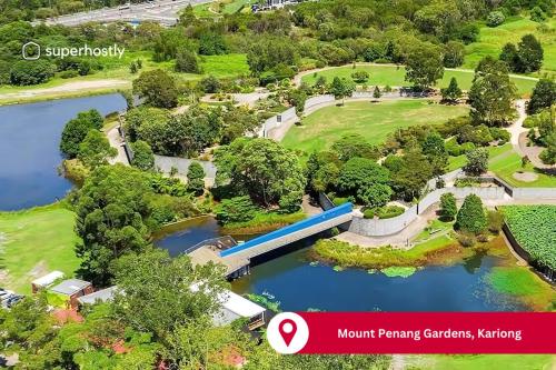 an aerial view of a park with a bridge over a lake at Tranquility with Spa & Jetty in Woy Woy