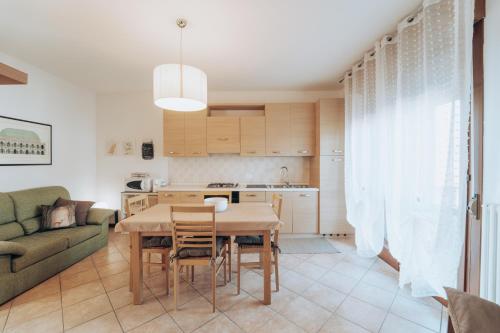 a kitchen and living room with a table and a couch at Civetta 14 in SantʼAntonio