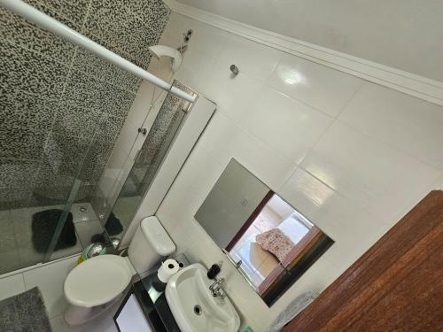 a small bathroom with a toilet and a sink at Casa Brisa da ilha in Florianópolis