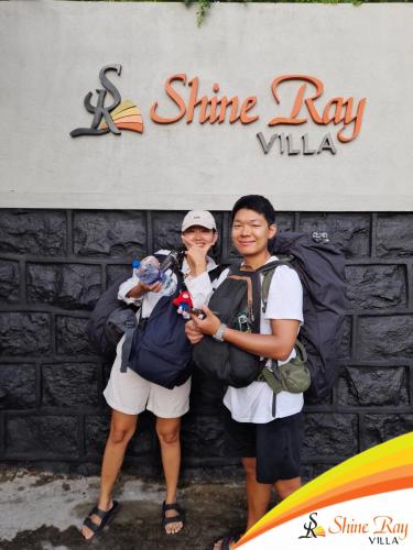 two women standing in front of a stone wall at Shine Ray VILLA in Galle