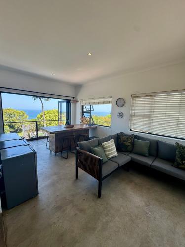 a living room with a couch and a table at Ballito Ocean View Holiday Home in Ballito