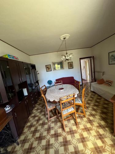 a dining room with a table and chairs in a room at La casa in castello in Bolsena