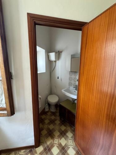 a bathroom with a toilet and a sink at La casa in castello in Bolsena
