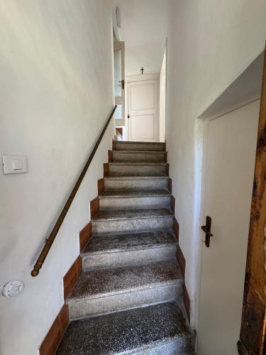 a staircase in a house with a white door at La casa in castello in Bolsena