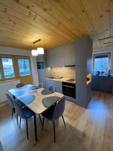 a kitchen and dining room with a table and chairs at Chata Petra in Oravský Biely Potok