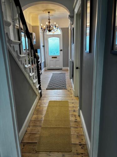 a hallway of a home with a chandelier at Stunning fully refurbished house in New Quay