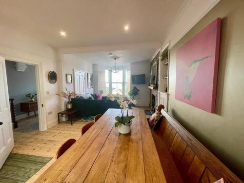 a living room with a wooden table and a couch at Stunning fully refurbished house in New Quay