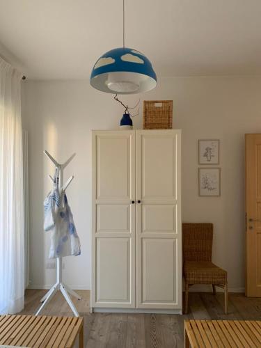 a room with a white cabinet and a blue light at Appartamento caneve in Arco