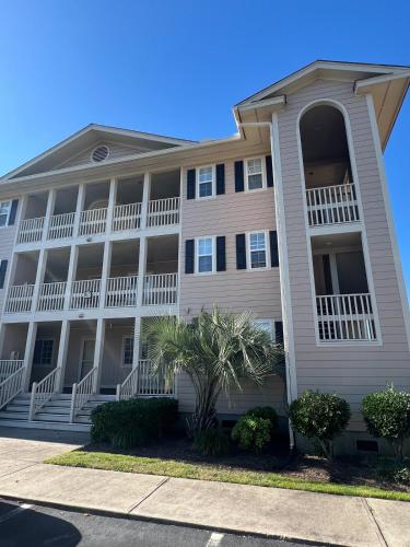 a large white building with balconies at Cherry Grove 1BR screened porch 2nd Floor view in Myrtle Beach
