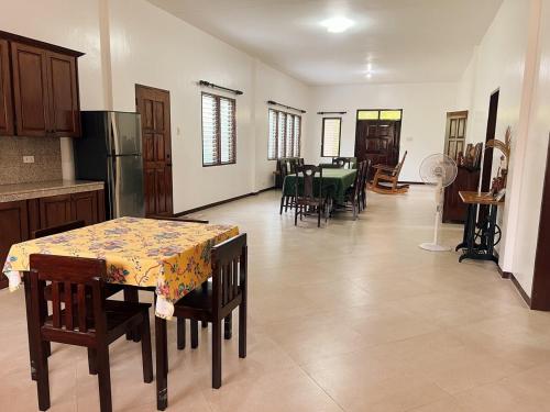 a kitchen and dining room with a table and chairs at Casa Carmencita Cebu - Ocean and garden villa in Asturias, Cebu in Asturias
