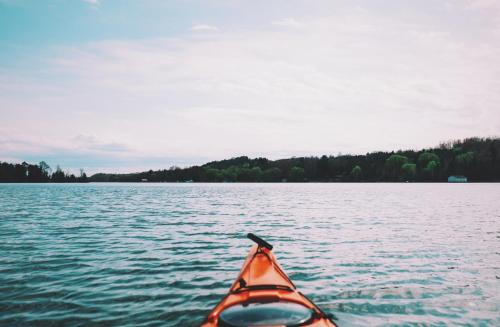 an orange kayak on a large body of water at Cottage 7 - Stand Alone 1 Bedroom / 1 Bath in Wolfeboro