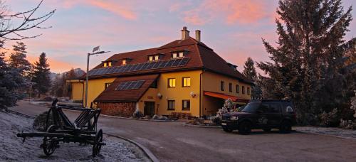 a truck parked in front of a yellow house at Mlyn Tatry in Veľký Slavkov