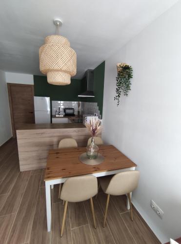 a dining room with a wooden table and chairs at Casa rural La Pinada in Villanueva de Viver