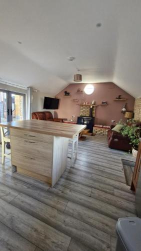 a living room with a table and a couch at Yellow Stone Farm Lodge in Clonbrown