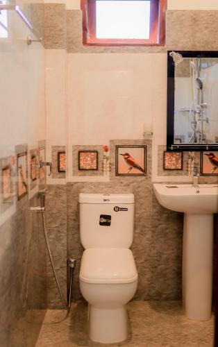 a bathroom with a toilet and a sink at Sea Breeze Place Hiriketiya in Dickwella
