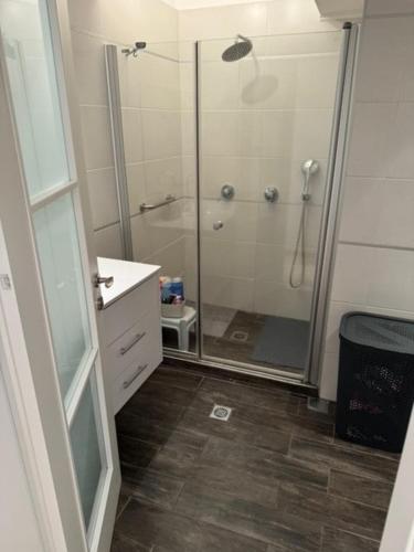 a bathroom with a shower with a glass door at Awesome Apartment Netanya in Netanya