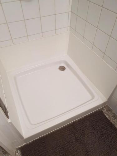 a white bath tub with a drain in a bathroom at Studio in Fresnes in Fresnes