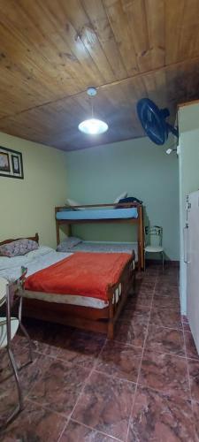 a bedroom with a bed and a wooden ceiling at La casita del parque in Mar del Plata