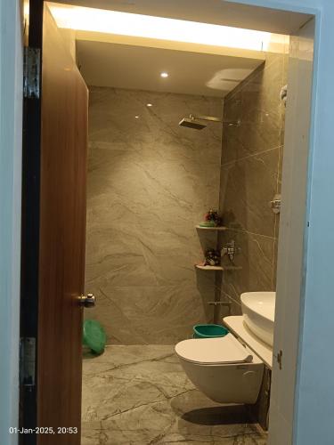 a bathroom with a toilet and a sink at Om Nivas in Bhuj