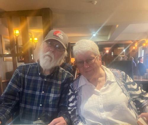 an older man standing next to an older woman at Family room in Broadstone