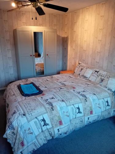 a bedroom with a bed with a comforter on it at Family room in Broadstone