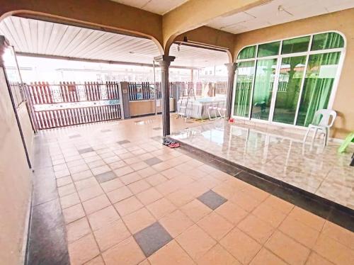 une pièce vide avec un balcon avec des tables et des chaises dans l'établissement D'Amal Homestay Alor Setar, à Alor Setar