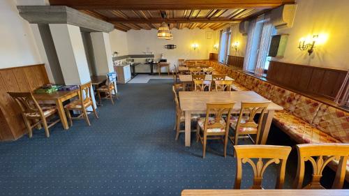 a dining room with tables and chairs in it at Botenwirt - Self Check in in Spital am Pyhrn