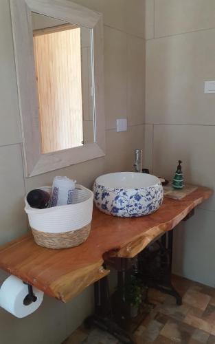 a bathroom with a sink and a mirror on a counter at cabaña, casa de campo IKIGAI in Quillón