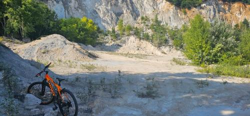 an orange bike is parked on a dirt road at Jsjdjd in Prievidza
