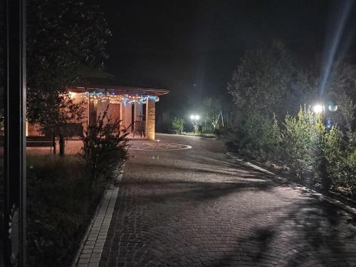 a brick road with a building at night at Dimora Cice in SantʼAgata deʼ Goti