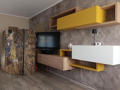 a living room with a refrigerator and a television at Belvedere Vallata Affitti brevi in Vallata