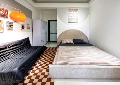 a bedroom with two beds and a checkered floor at Luxe Paradise 21 Nguyen Van Troi in Hanoi