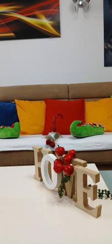 a bed with a table with a sign that says eat at Apartment FUNNY in Kotor