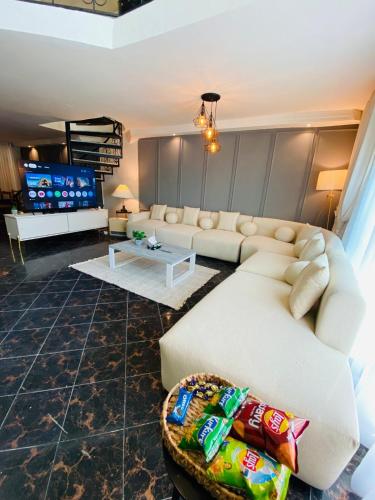 a living room with a couch and a table at SUPERHOST Apartments - Near GPO & Mall Road in Murree