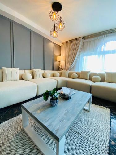 a living room with a couch and a table at SUPERHOST Apartments - Near GPO & Mall Road in Murree