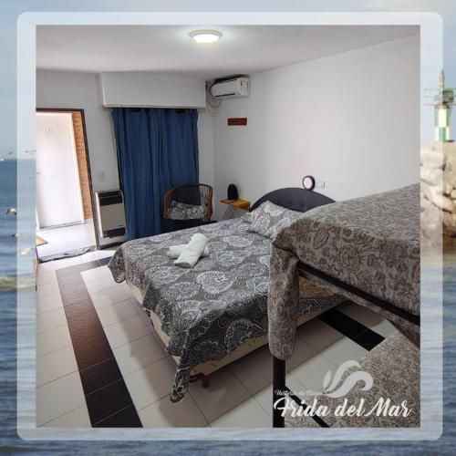 a bedroom with a bed and a room with the ocean at Frida del Mar in Playa Unión