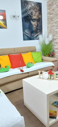 a living room with a couch with colorful pillows at Apartment FUNNY in Kotor