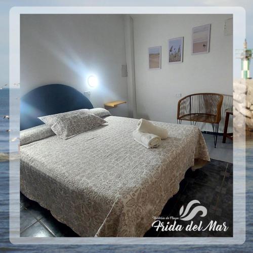 a bedroom with a large bed and a chair at Frida del Mar in Playa Unión