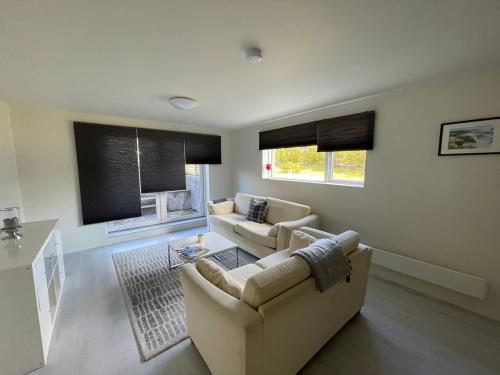 a living room with two chairs and a couch at Beautiful Central Apartmant in Strand