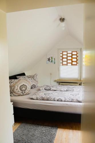 a bed in a room with a window at Studio an der Ilmenau in Lüneburg