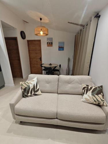 a living room with a couch and a table at Chez Tom et Yas in Le Barp