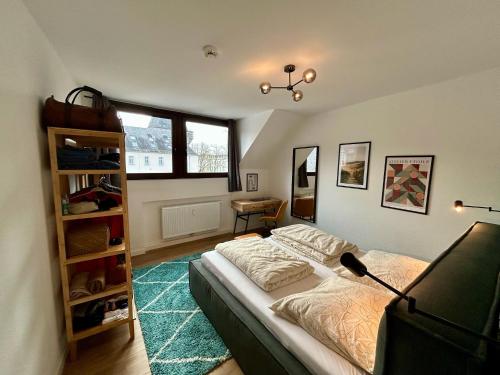 a bedroom with a bed and a book shelf at Karl Central Flats - Netflix - Parkplatz - Balkon in Trier