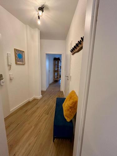 a living room with a blue couch and a hallway at Karl Central Flats - Netflix - Parkplatz - Balkon in Trier