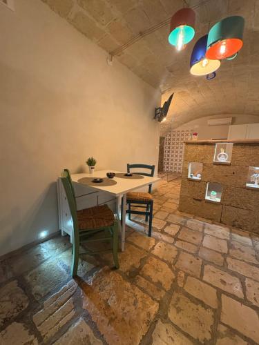 a dining room with a table and two chairs at Vico Luxury Room in Mesagne