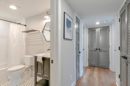 a white bathroom with a toilet and a sink at Gorgeous 2 Bedroom Historic Franklin Quadplex in Franklin