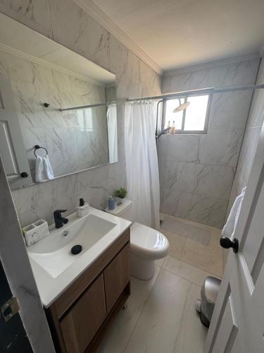 a white bathroom with a sink and a toilet at Casa Privada Descanso Naturaleza in Maule