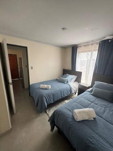 a bedroom with two beds and a window at Casa Privada Descanso Naturaleza in Maule
