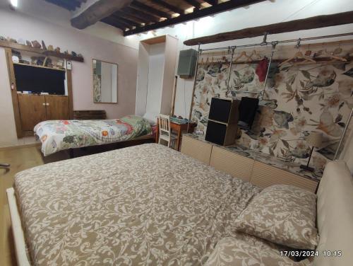 a bedroom with two beds and a stone wall at Casa della spiaggetta in Rio Marina