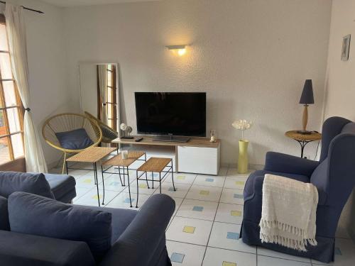 a living room with a blue couch and a tv at Maison 3 pièces BANYULS SUR MER BN000-040 in Banyuls-sur-Mer