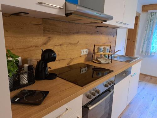 a kitchen with a black dog sitting on a counter at Selauerbauer in Lofer